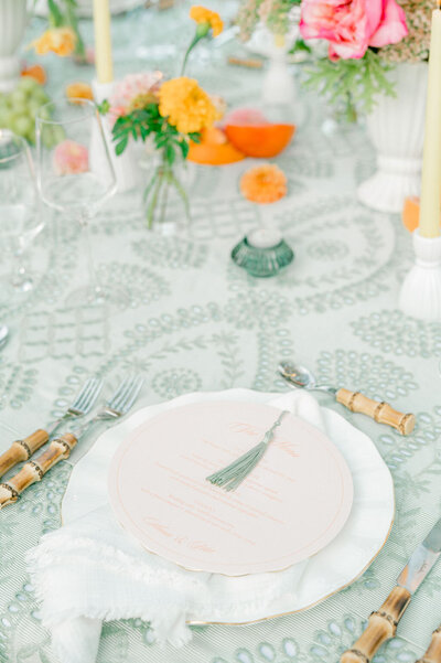 green and white place setting with menu