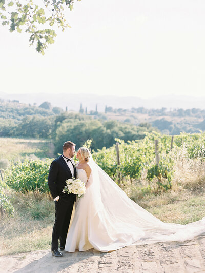 Bride and groom embracing in the countryside photographed by Chicago editorial wedding photographer Arielle Peters