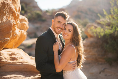 Utah Wedding Photographers capture mountain wedding bridal portraits with bride and groom smiling after destination elopement
