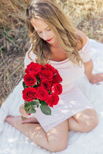 Image of Keri looking at red roses