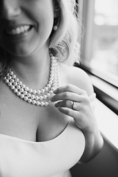 A candid, editorial-style photo of a bride holding a glass of champagne while getting ready on her wedding morning in Milwaukee. Captured by Alexia Rodriquez, a destination wedding photographer specializing in timeless, artful wedding day storytelling.