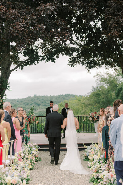 A couple in wedding attire at their outdoor wedding reception at Willow Hill Events