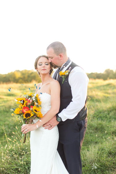 Bride and groom portrait with sunflowers