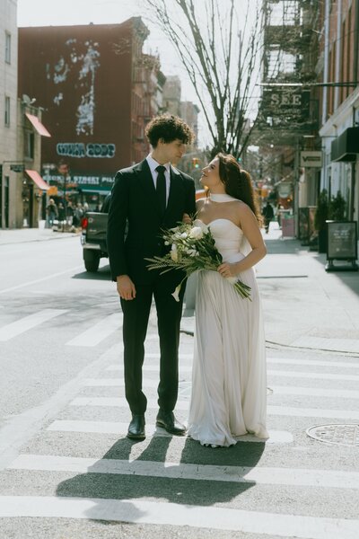 Elopement session couple walks through the street in new york city