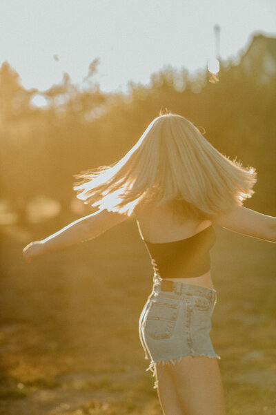 girl twirling during golden hour