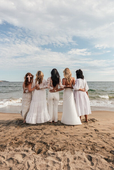 kat smiling with black jacket on shoulders
