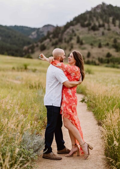 Couple hugs at Chautauqua Park in Boulder, Colorado during their engagement session with Colorado engagement photographer Avenir Photo Co.