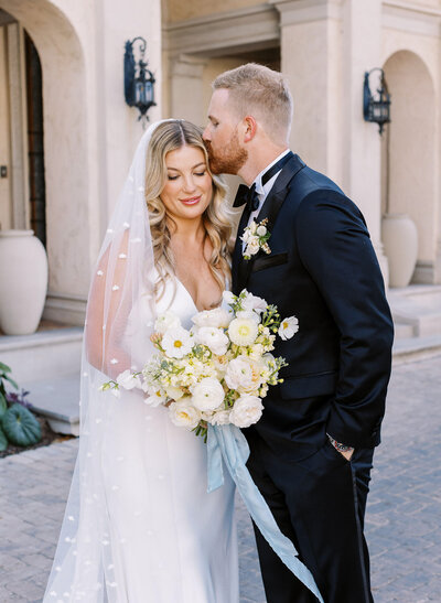 Bride and groom walk up front steps of woodbine mansion in texas