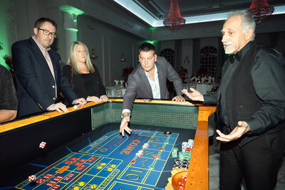 Guests playing craps during a casino night fundraiser at Valley Regency in NJ