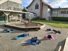 Children doing yoga outside of Burnaby Montessori School