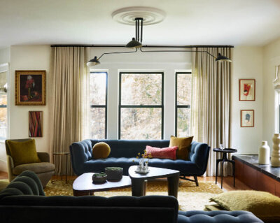Boston interior designer designed a formal living room with modern furniture and mid-century modern lighting, blending classic architecture with updated style.