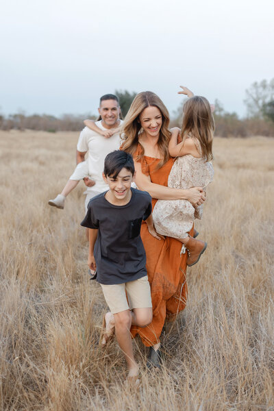 beautiful family in field posing manteca family photographer