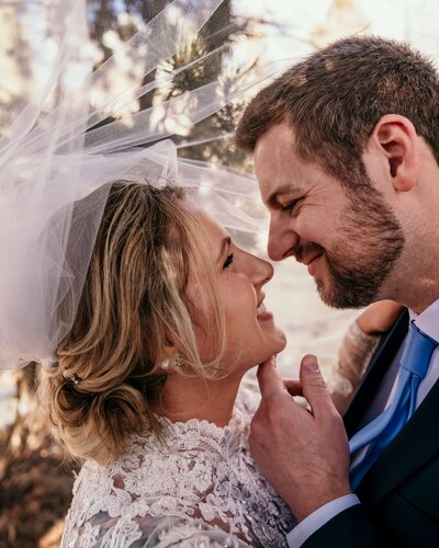 bride and groom smiling at each other