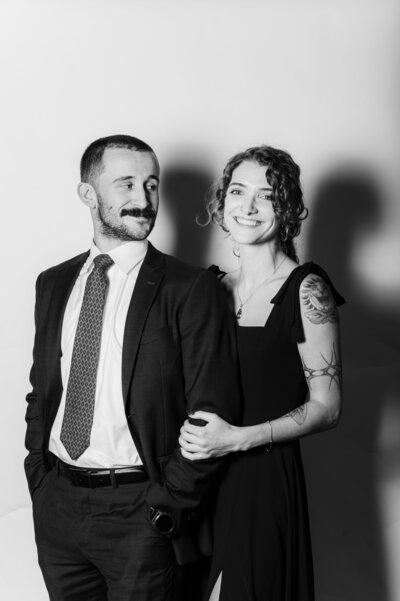 Black and white portrait of a smiling couple posing together at a Vogue Portrait photo booth in Richmond, VA.