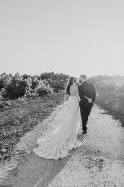 black and white bride and groom walking into sunset at Gerry Ranch