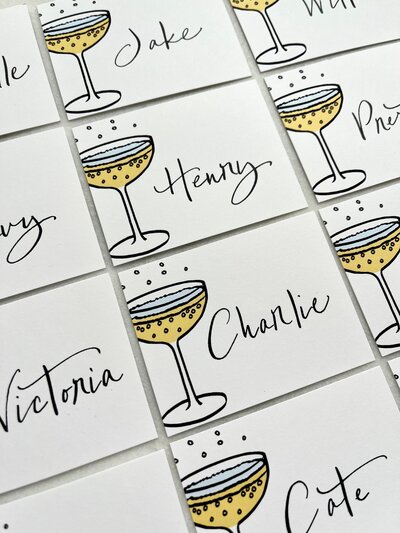 Champagne coupe place cards  with black calligraphy