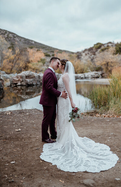 Bride and Groom kiss at wedding in East San Diego County at a lake