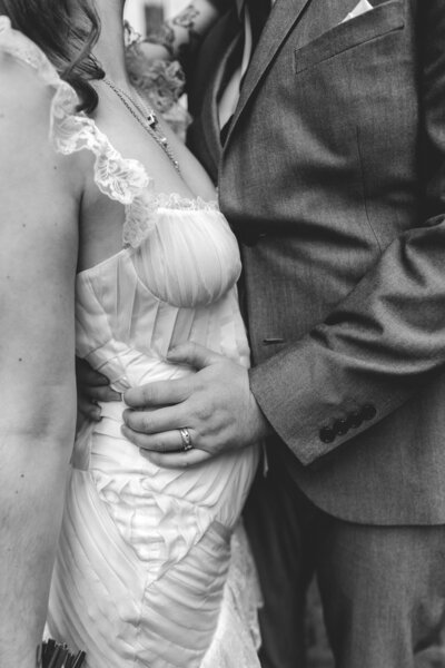 BRIDE RUNS THROUGH THE GARDENS OF CASWELL HOUSE IN BLACK AND WHITE