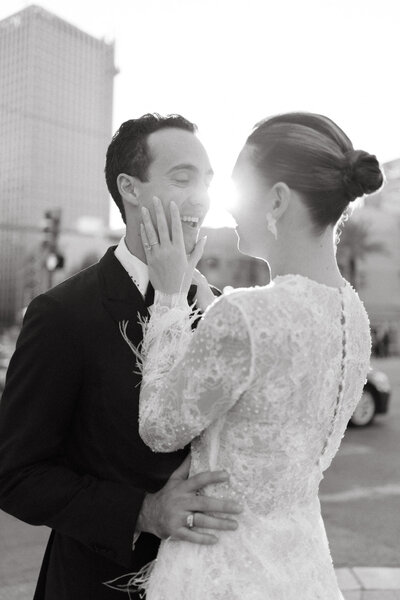 Bride in strapless sculptural gown holding a coupe glass during wedding celebration