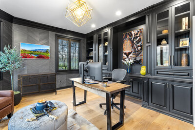Dark wood dining table with light chairs and flower feature