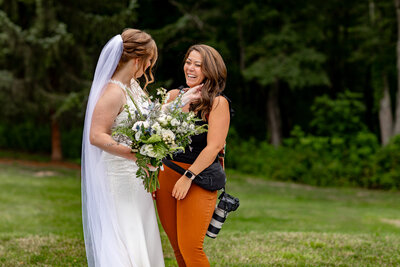 photographer smiling with bride