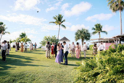 Bride and groom walking hand in hand through Isabela, Puerto Rico