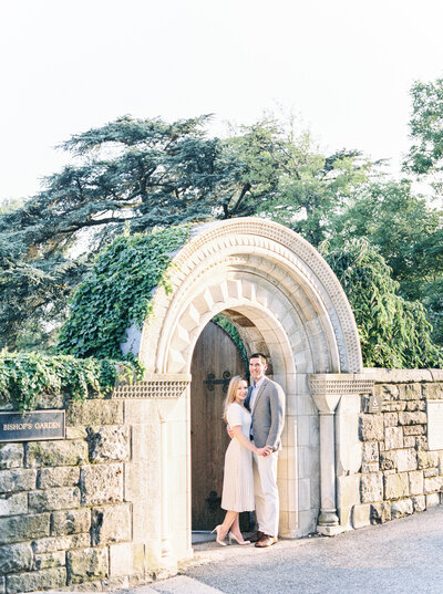 Couple kissing under arched stone gate – Washington DC Wedding Photographer