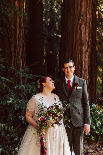 Bride and groom stand in front of redwood tree for couples portrait