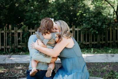 Candid portrait of a family hugging during a family photo session in Batavia, IL by Moments by Meli