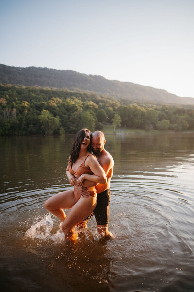 couple in bathing suits laughing in tennessee river