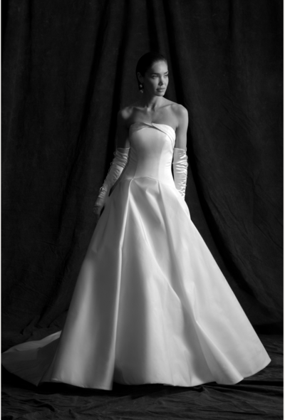 Faille strapless ball gown with draped cuff neckline. Box pleated a-line skirt with chapel-length train. Detachable watteau train panels.