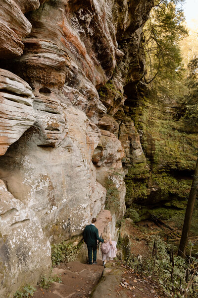 Couple hiking out of Rock House at Hocking Hills.
