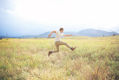 senior boy jumping for joy in Boulder, CO by Leighellen Landskov Photography.  Simple, Joyful, Authentic.