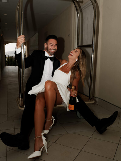 Couple taking engagement pictures at Surf and Sand in Laguna Beach