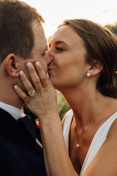 Bride and groom kissing close up by film wedding photographer Noble Photo Co