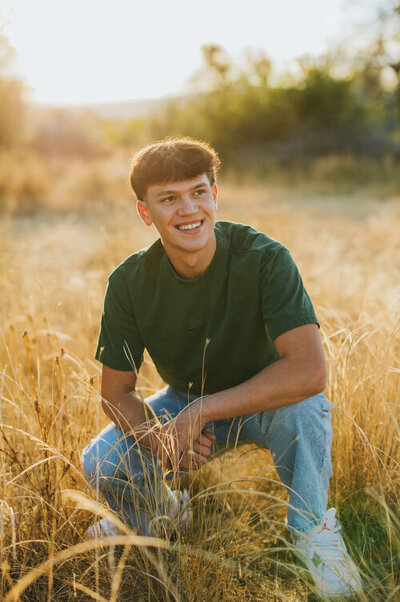 Guy smiling during golden hour senior shoot Tri Cities