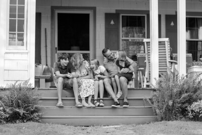 Family sitting on their porch together | Family Session