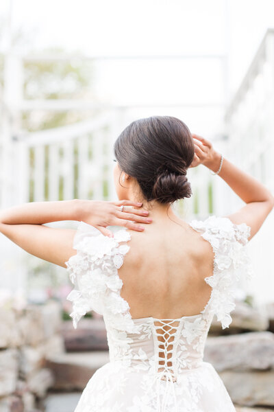 Back of bride wedding dress with hand on her head