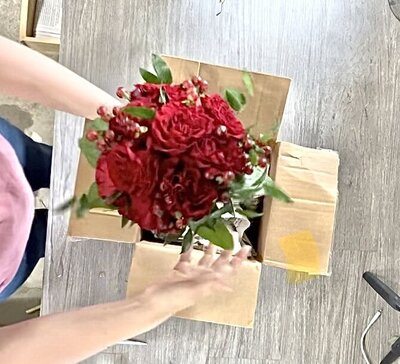 bride and groom kissing outside the Logan LDS Temple bride holding white and blue wedding bouquet
