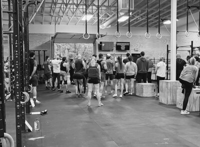 Members of Skopos Athletics in Dundas, MN gathering for a community fitness event, building strong connections through health and wellness activities.