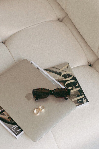 Laptop and sunglasses representing showit template customization by Palme Design Co