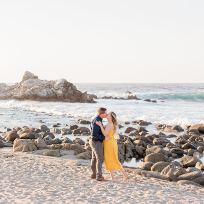 Couple on beach in pacific grove engagement photograph