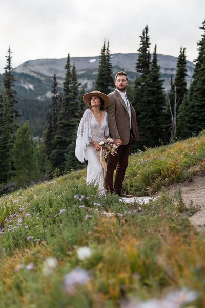 a elopement couple gaze off into the distance taking in the view of Mt. Rainier