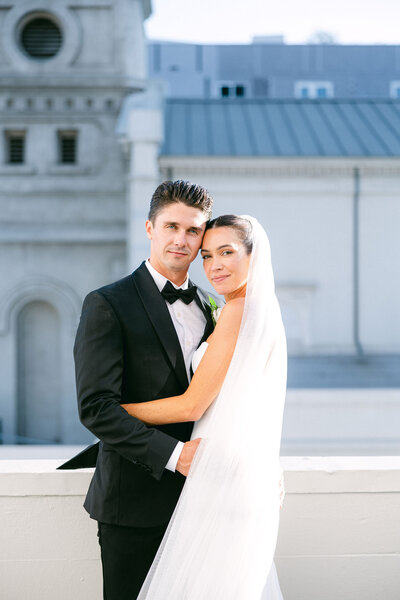 bride and groom portrait taken on the balcony at Vibiana overlooking the city of Los Angeles captured by los angeles wedding photographer magnolia west photography