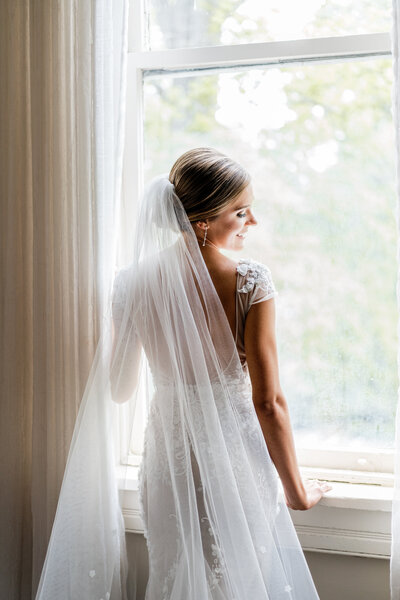 bride posing by window