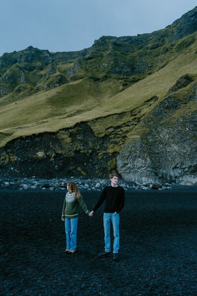 couple in iceland on black sand beach