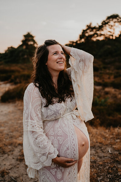 zwangere vrouw met zwangerschapshoot tijdens golden hour