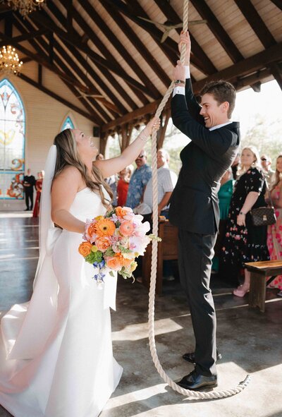 Bride and groom rings chapel bell at La Bonne Vie Ranch