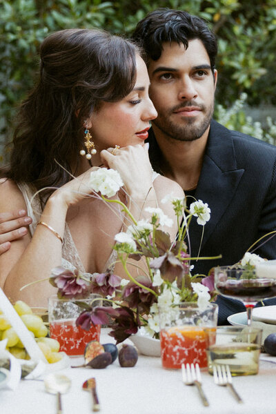 Bride and groom seated at an elegant garden party wedding tablescape in Los Angeles, styled with romantic florals and vintage-inspired details by Jasper & Lane Event