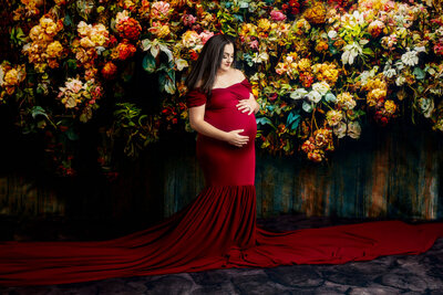 Pregnant woman in red dress in  photo session with Melissa Byrne